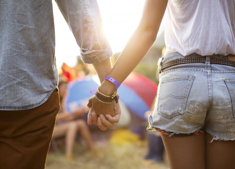 close up of two people holding hands