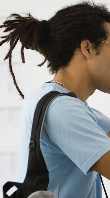 teenage male writing up against a wall