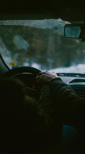 view from backseat rider in a car looking at the driver