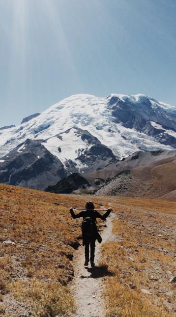 Young male hikes around Mt. Rainier in Washington.