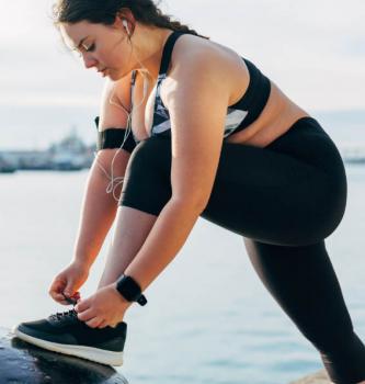 girl exercising tying her shoes